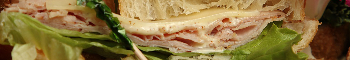 Eating Deli Sandwich at Arthur's Garden Delicatessen restaurant in Rock Island, IL.